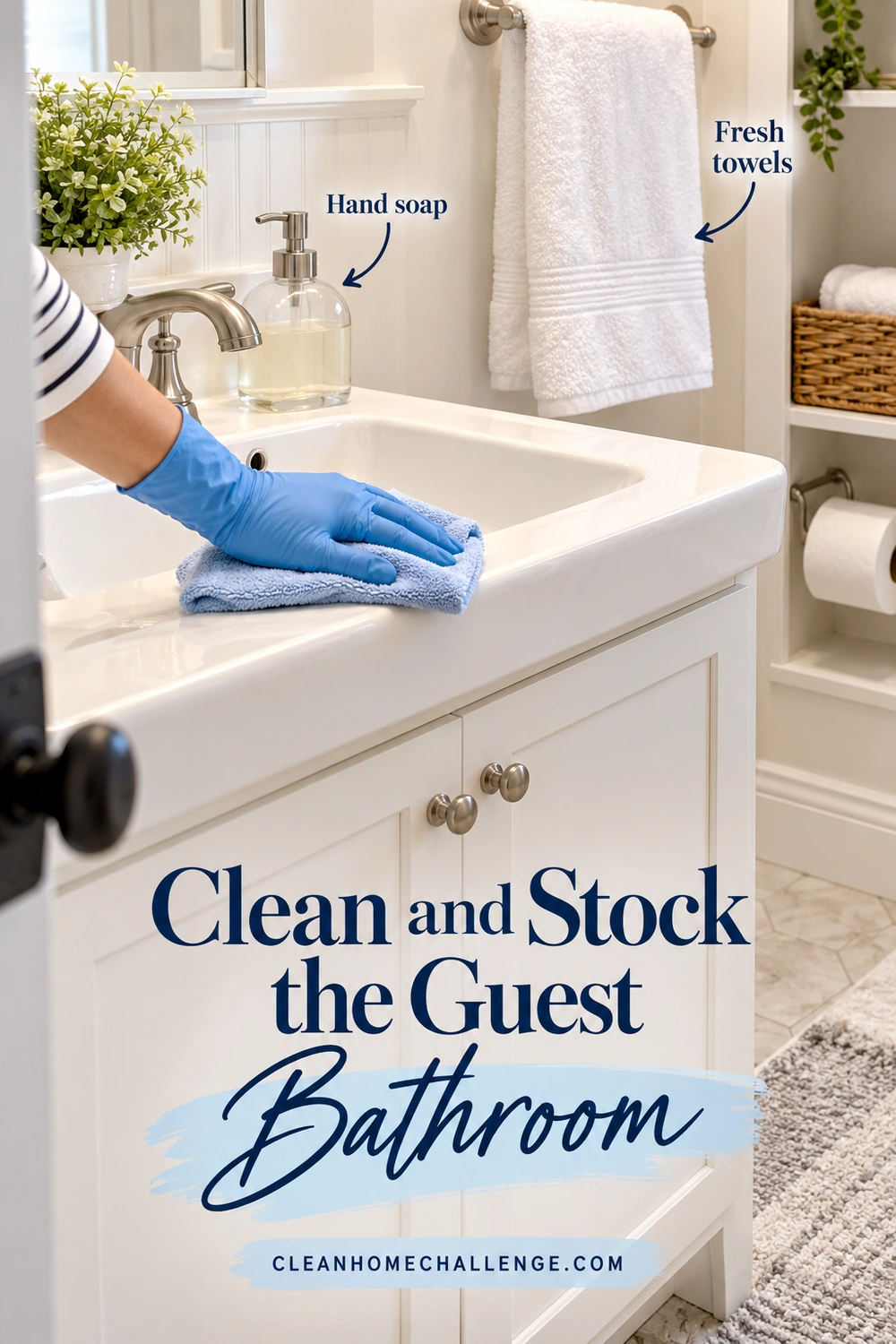 A blue-gloved hand wipes the rim of a ceramic bathroom sink with a blue cloth. A soap dispenser, hanging white hand towel, and toilet paper are easy to see.