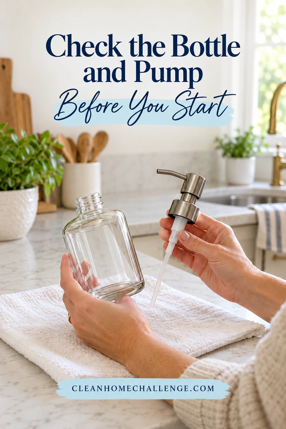 Hands hold an empty clear glass dispenser bottle and separate metal manual pump over a clean white towel.
