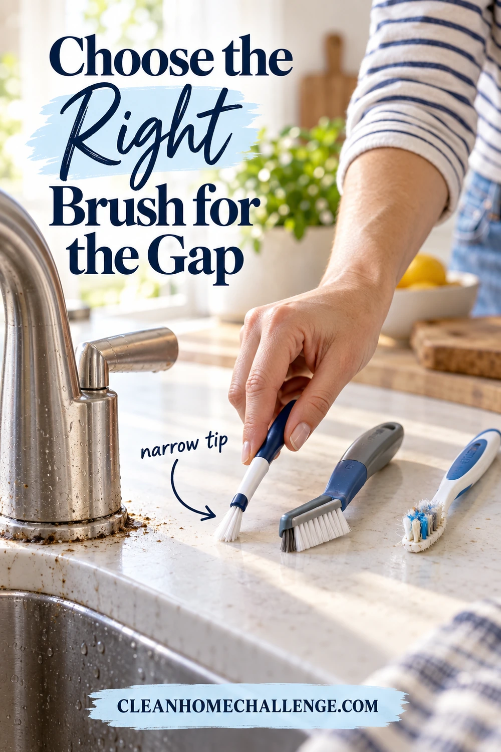 A hand holds a narrow blue-and-white detail brush beside two other small brushes at a kitchen sink.