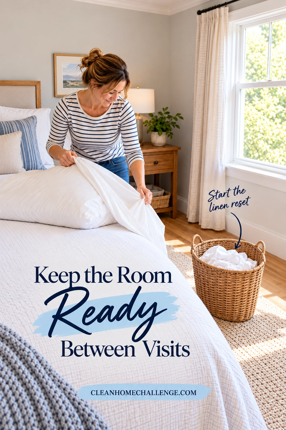 A woman removes a white pillowcase beside a guest bed and a wicker laundry basket holding used linens.