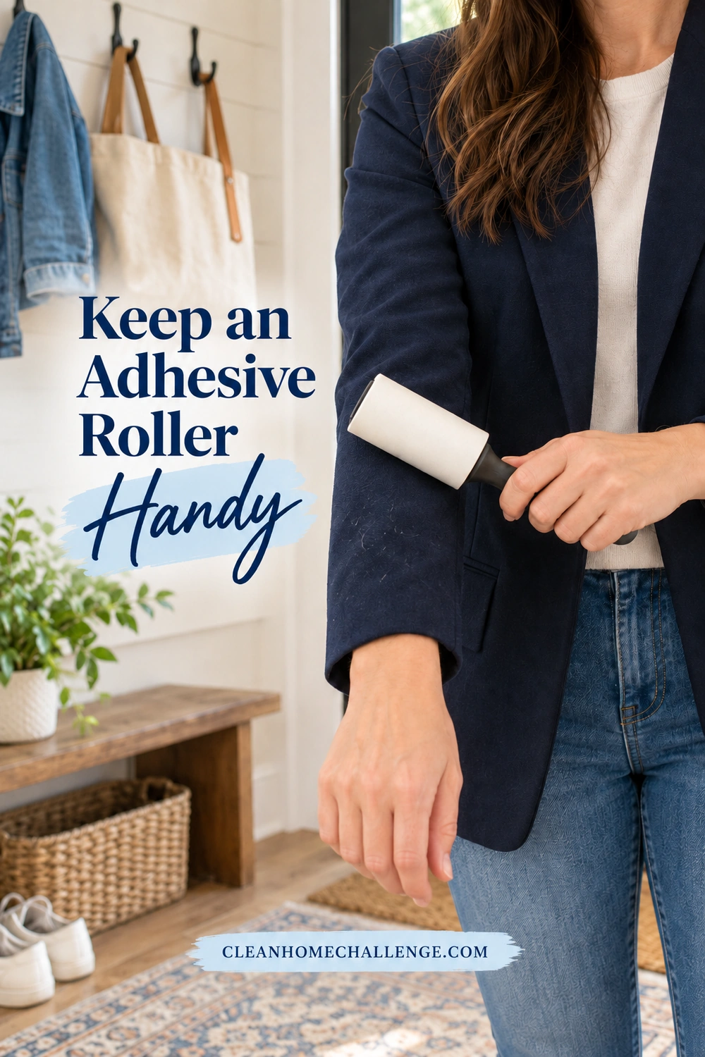 A woman in a navy blazer uses a white adhesive lint roller on her sleeve in a home entryway.