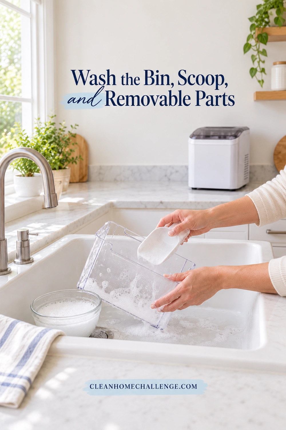Hands wash a detached clear ice bin and white scoop over a sink; the ice maker remains on a dry counter behind them.