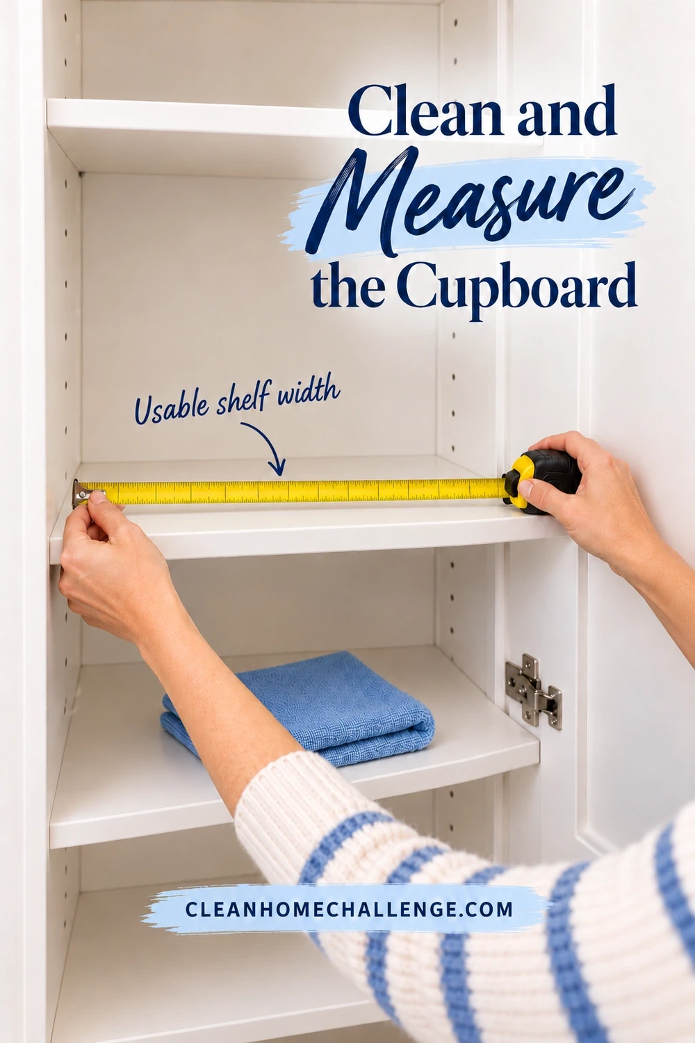 Two hands stretch a yellow measuring tape across an empty white cupboard shelf, with a folded blue cleaning cloth on the shelf below.