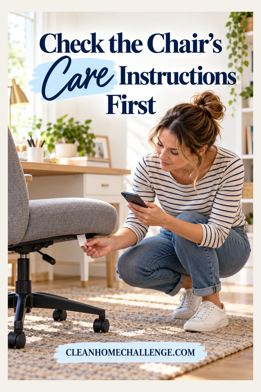 Woman crouching beside an upright gray office chair, holding its care tag and checking her phone.