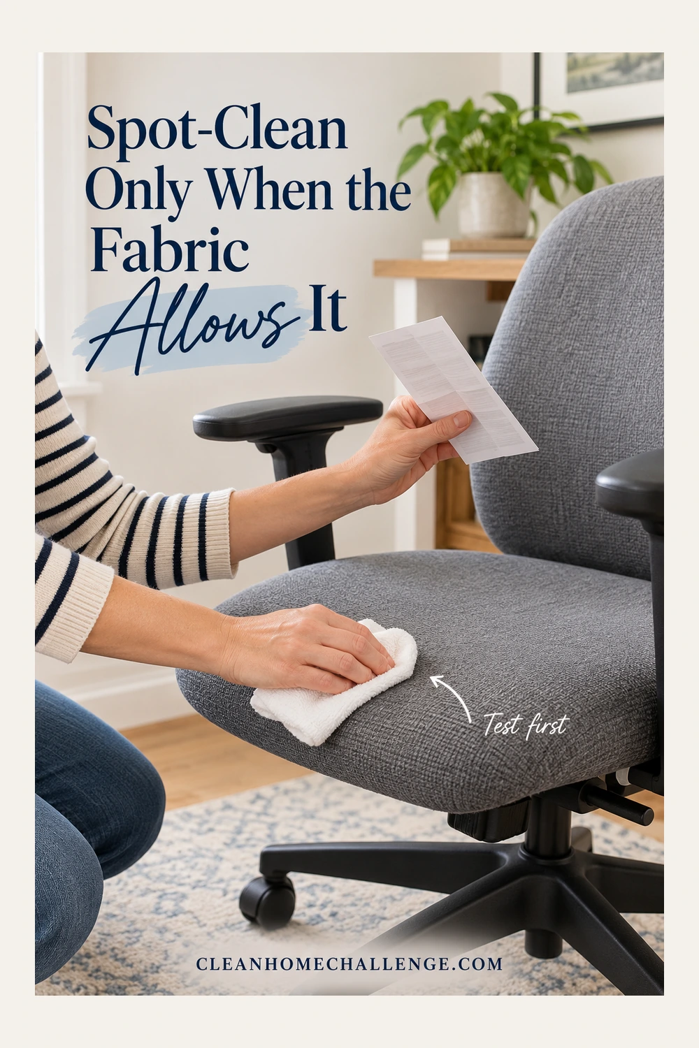 Hands holding a care sheet and a white cloth at the corner of a gray upholstered office-chair seat.
