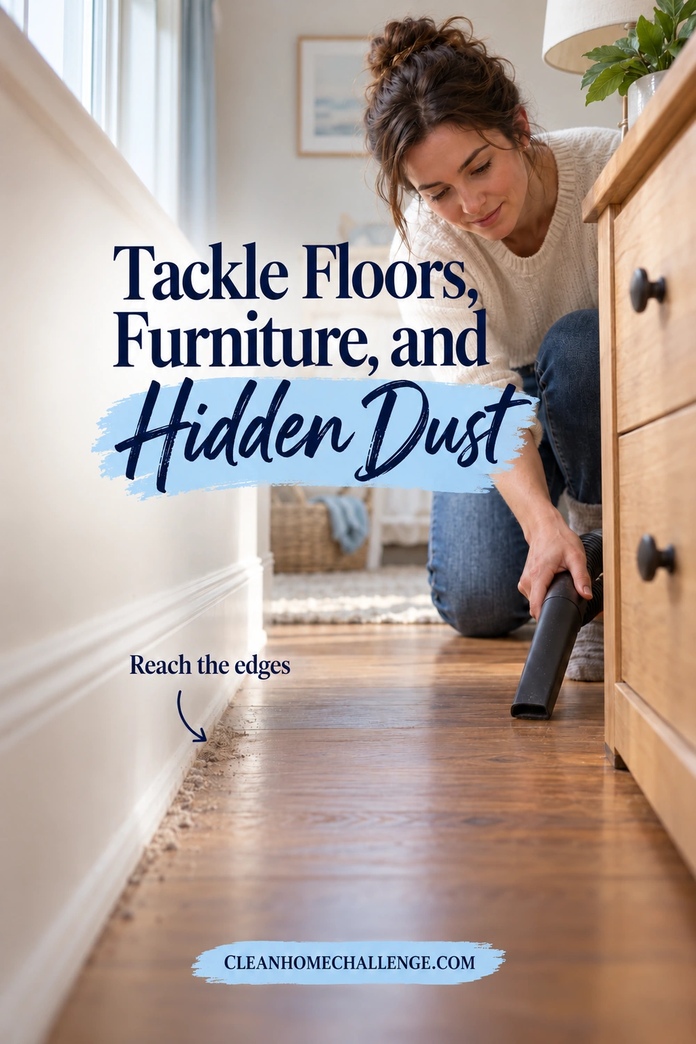 A woman uses a vacuum crevice attachment on the wooden nursery floor beside a dresser, with dust visible along the baseboard.
