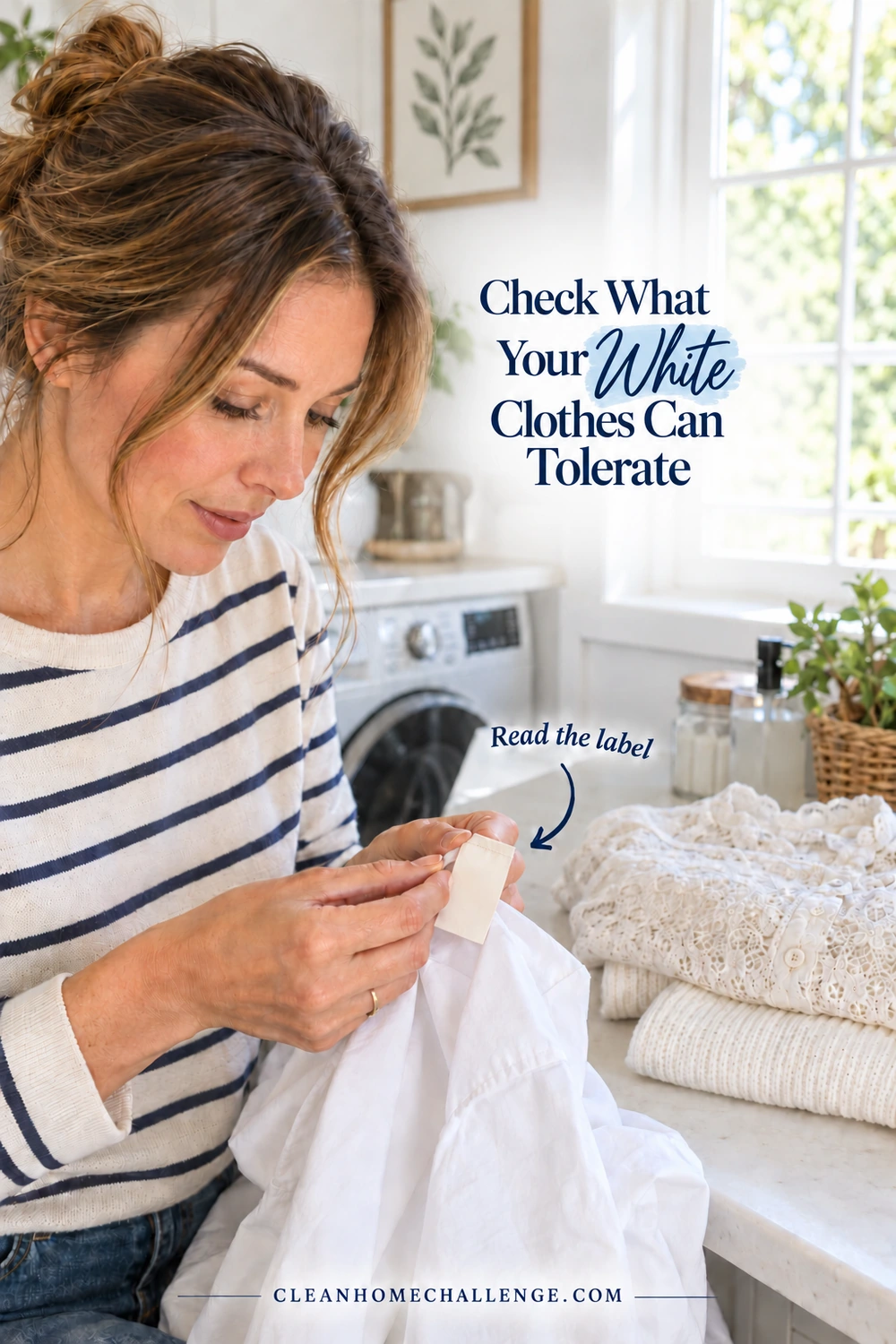 A striped-shirt woman examines a small garment tag beside white lace and folded knitwear.
