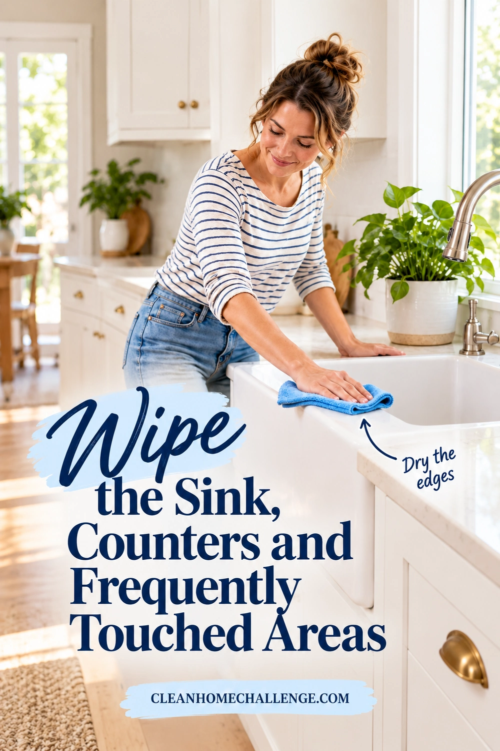 A woman wipes the rim of a laundry sink with a blue cloth on a white laundry counter.